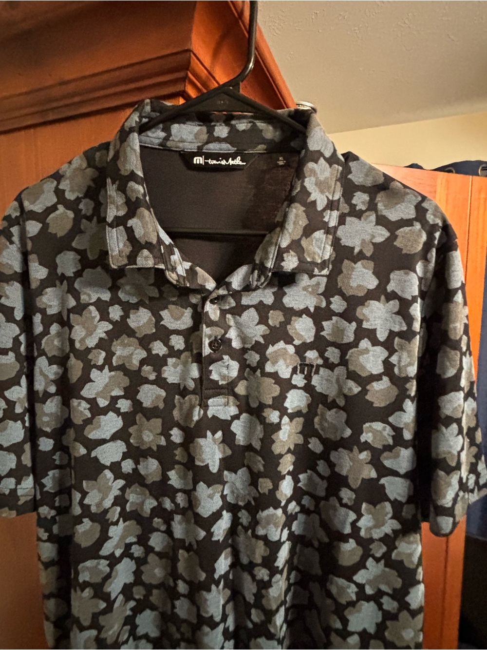 Travis Mathew Black Polo with Light Blue Floral Print